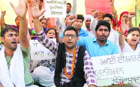 Members of the Inclusive Education Resource Teachers Union hold a protest at Phase VIII in Mohali on Wednesday.