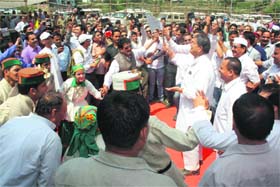 Chief Minister Harish Rawat enjoys a traditional dance at Gairsain on Wednesday