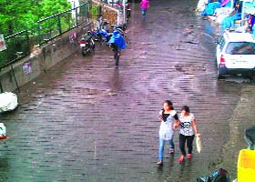 Tourists enjoy walking during a brief spell of rain in Mussoorie on Wednesday