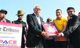 Governor NN Vohra receives a memento from PHE Minister Sham Lal Sharma after he flagged off the walkathon in Srinagar on Wednesday.