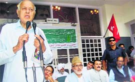 National Conference president Farooq Abdullah addresses workers at paty headquarters in Srinagar on Wednesday.