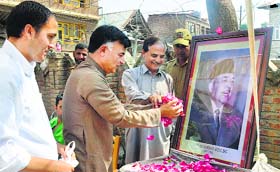 Former National Conference MP Mehboob Beg pays tributes to his late father and party leader Mirza Mohammad Afzal Beg at Sarnal in Anantnag district on Wednesday.