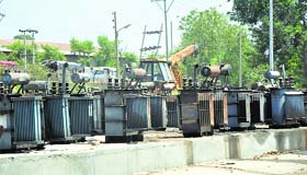 Damaged transformers lie at a Power Development Department workshop in Jammu.