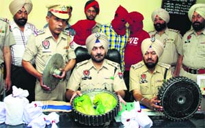 The police show the heroin recovered from a mustard seed crusher in Jalandhar on Wednesday. 