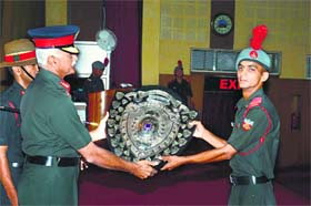 Indian Military Academy Commandant Lt Gen Manvendra Singh awards a trophy to a cadet in Dehradun on Wednesday