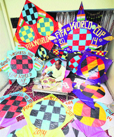 Kite-maker Jagmohan Kanojia works on making soccer FIFA World Cup 2014 kites at his workshop in Amritsar on Thursday.