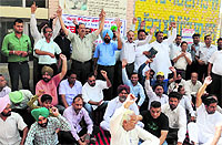 Members of the Punjab Chemists Association stage a protest against the state government at the Civil Hospital in Bathinda on Thursday.