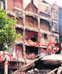 1 A damaged pillar of the building adjoining the collapsed NIELIT structure; 2 a gaping hole in the wall; and 3 damaged iron bars that pose a threat to it. 