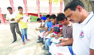 Students fill their forms to seek admission to Class XI at Government Model Senior Secondary School, Sector 10, Chandigarh, Thursday.