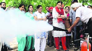 A man demonstrates fire-fighting techniques at the Civil Hospital in Mohali on Thursday.