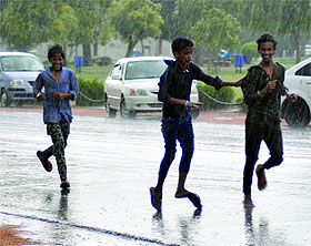 Boys enjoy in the rain at Rajpath in New Delhi on Thursday. The showers brought the much-awaited respite to Delhiites from heat. The maximum temperature today recorded at 41.1 C. 