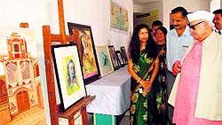 Governor Aziz Qureshi looks at a painting at Bhimtal campus of Kumaon University on Thursday
