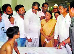 Chief Minister Harish Rawat with one of the acid attack victims at Sushila Tiwari Hospital in Haldwani on Thursday