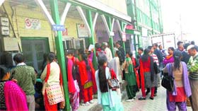 Patients wait outside at Ripon Hospital, known as Deen Dayal Hospital, in Shimla