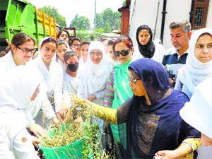 Students and staff of Womens College, MA Road, during the sanitation drive in Srinagar on Thursday. 