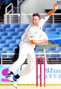 New Zealands Mark Craig bowls during the second innings on the fourth day of their first Test against West Indies in Kingston.