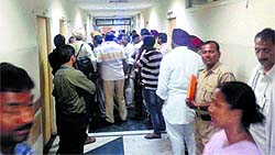 Relatives of accident victims and investigating officers wait outside the Senior Medical Officers room to give applications for post-mortem examination and release of bodies at the PGI on Friday
