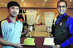 Indian billiards player Saurav Kothari (right) and Thanawat Thirapongpaeboon (snooker player) from Thailand with the trophies of the 13th ONGC Asian Billiards and Snooker Championship at Hotel Shivalik View, Sector 17, Chandigarh, on Friday