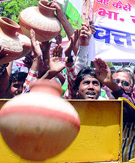 Activists of the Congress hold a protest outside the BJP office against power crisis in Delhi on Friday. 