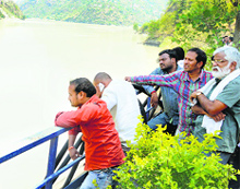 Relatives of the missing students on the bank of the Beas near Pandoh in Mandi on Friday. 