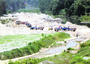 Vehicles carry out mining operations in the Balh valley in Sundernagar on Friday