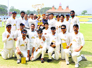 The winners of the HP Lawyers T-20 Cricket Tournament receive the trophy from former Chief Minister Prem Kumar Dhumal at the HPCA stadium in Dharamsala on Friday.