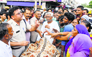 DSP Joginder Rathi tries to pacify protesters in Karnal on Friday.
