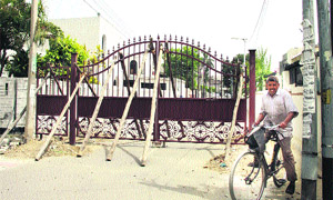 An iron gate being installed at the entrance to New Jawahar Nagar in Jalandhar on Friday.