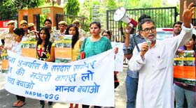 Activists protest against increasing the height of Sardar Sarovar Dam in Gujarat, in New Delhi on Friday.