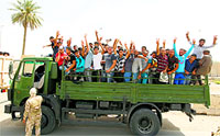 Volunteers who have joined the Iraqi Army to fight against Sunni militants gesture from an army truck in Baghdad on Friday.