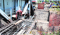 A worker repairs the damaged side of the Bhandari railway overbridge in Amritsar on Saturday. PHOTO: RK Soni