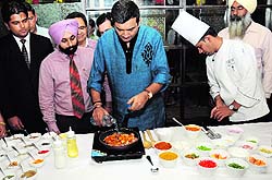 Chef Sanjeev Kapoor prepares a delicacy during the inaugural ceremony of an outlet of his chain of restaurants in Bathinda