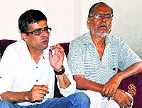 District Congress Committee spokesperson Puneet Malhi and the victims grandfather (right) at a press conference at Dharamsala on Saturday