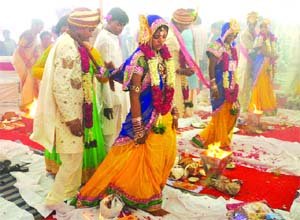 Couples take part in a mass marriage ceremony conducted in New Delhi on Sunday. 