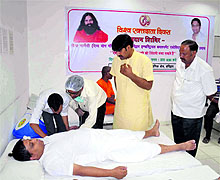 Acharya Balakrishan donates blood at a blood donation camp  in Haridwar on Saturday. 