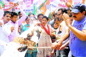 State Congress chief Ashok Tanwars wife Avantika Maken Tanwar and other party activists burn Union Minister Nihal Chand Meghwals effigy in Sirsa on Sunday