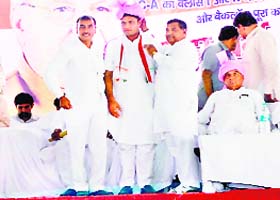 State Congress chief Ashok Tanwar is honoured at a function in Jind on Sunday as CM Bhupinder Singh Hooda looks on