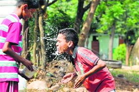 Children splash water over themselves in Shimla on a hot Sunday