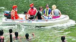 Students of Iowa States University enjoy boating with environmentalist Balbir Singh Seechewal (extreme left in turban) in the Kali Bein in Jalandhar on Sunday. 