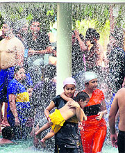 Girls enjoy rain dance at a water park in Jalandhar on Sunday.