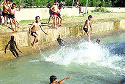 Summer splash: Children enjoy swimming in a river in Pulwamas Kakapora area on Sunday