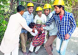 Municipal corporation workers detain a beggar from a street in Srinagar. Dozens of civic body workers descend on the streets and detained scores of non-local beggars who mostly arrive in the summer months from other states