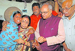 BJP leaders Balbir Punj (second from right), Kirti Azad, Abdul Rashid (R) and others console the daughter of Rahim Sheikh, who was brutally murdered at Kanur village in Birbhum district on Sunday. 
