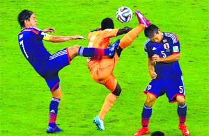 Japans Yasuhito Endo (left) and Yuto Nagatomo fight for the ball with Ivory Coast's Didier Ya Konan during their match at the Pernambuco arena in Recife on Saturday night.