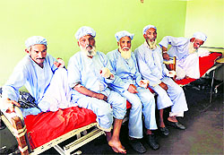 Afghan men show their bandaged hands after their fingers were cut by Taliban, in Herat province on Sunday.