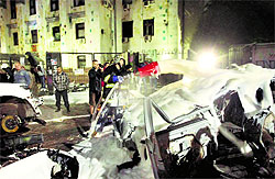 A Ukrainian firefighter pours foam onto smashed cars near the Russian Embassy during a rally in Kiev on Saturday.