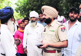 A police official speaks to the contractor in Amritsar on Monday.