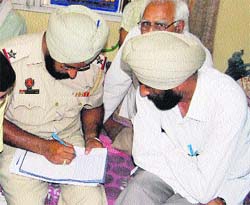 Police officials investigate suicide committed by Kavita by hanging herself from a ceiling fan in Amritsar on Monday. 