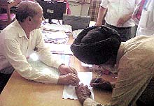 Present panchayat member Jarnail Singh signs at the office of the Deputy Commissioner after recounting of the votes