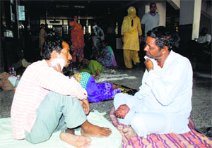 Attendants of patients sweat it out at the General Hospital, Sector 6, Panchkula. Power crisis has affected patient care at the hospital.